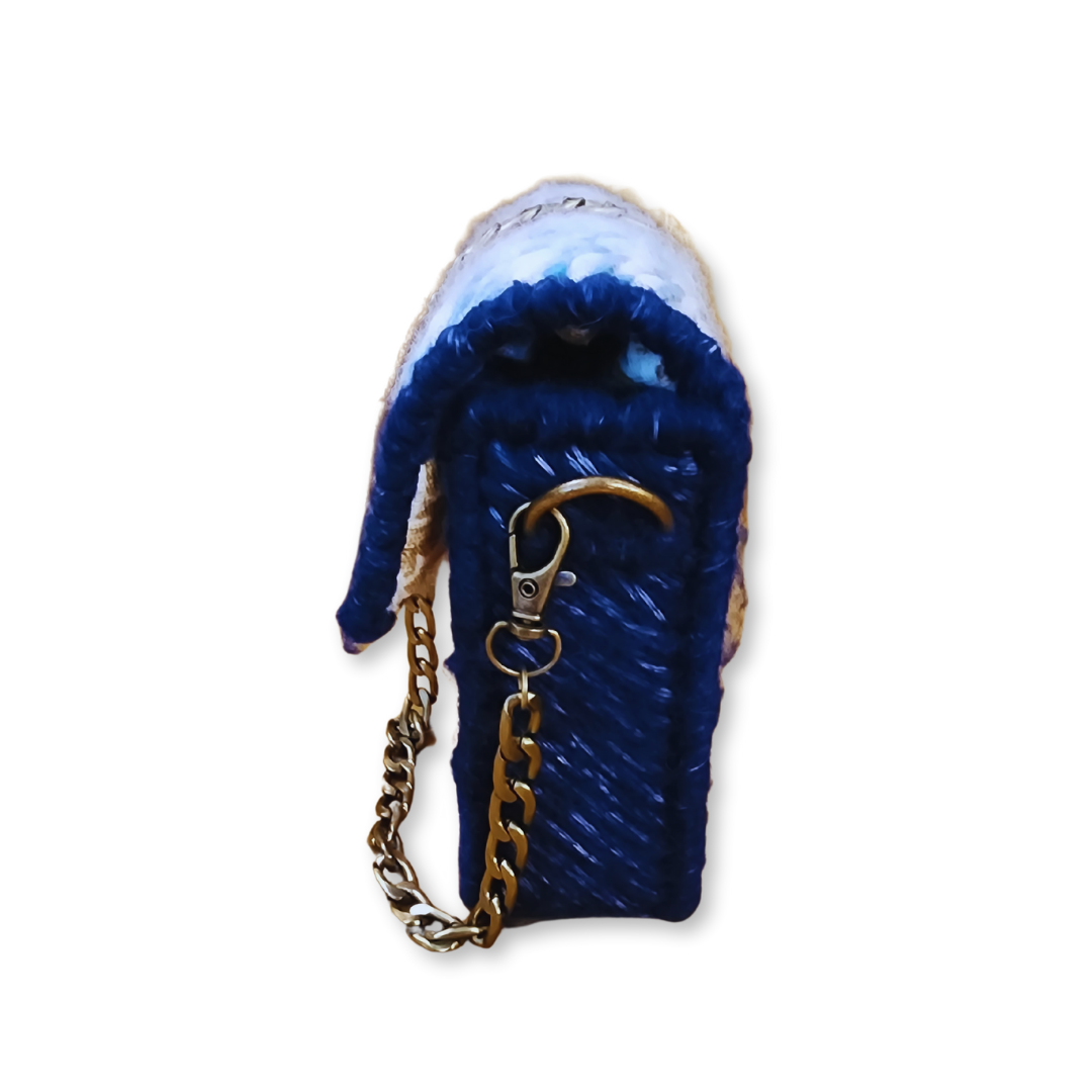 Side profile view highlighting the 2-inch depth and the lobster claw attachment for the removable bronze chain, demonstrating the bag's structural integrity.