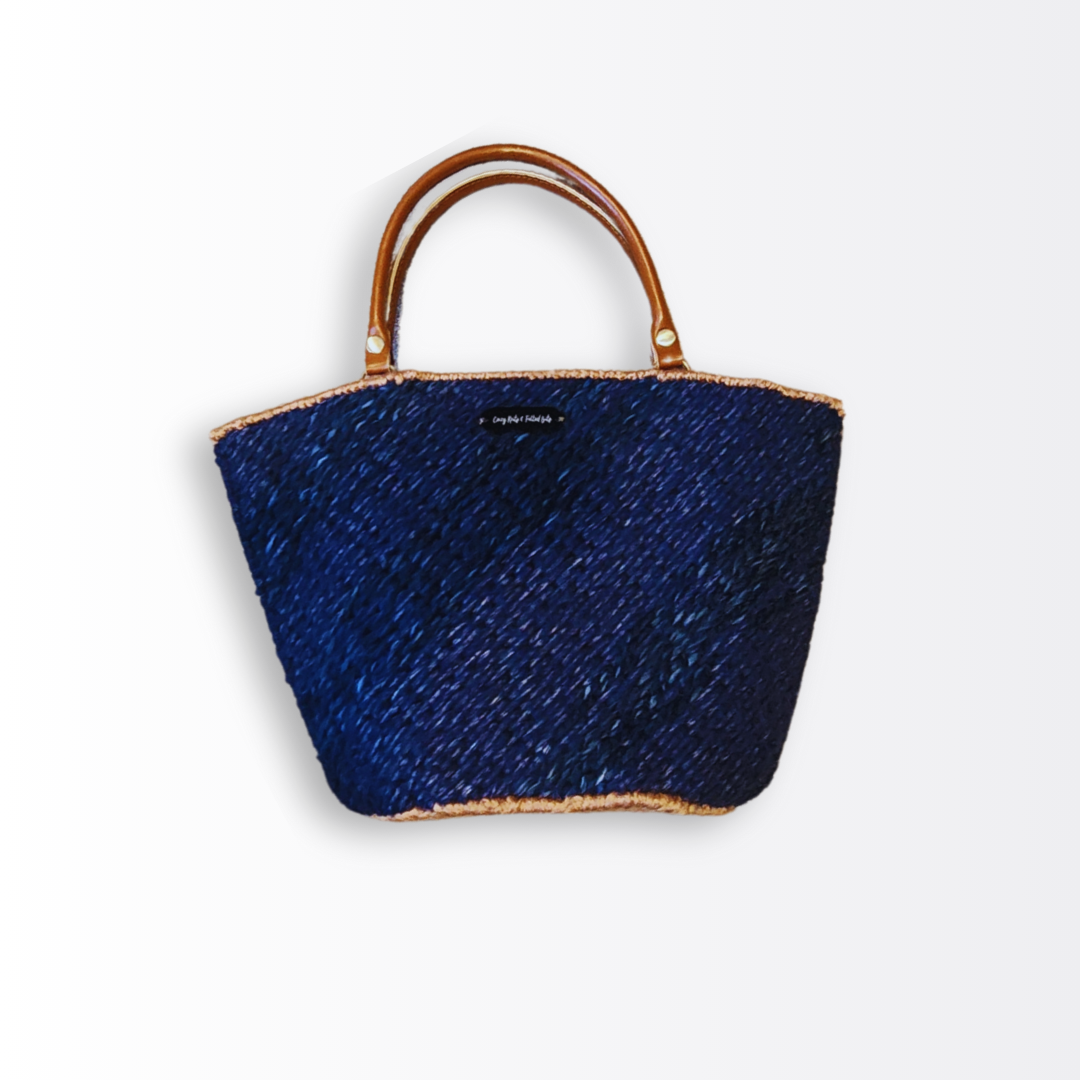 Front view of the Deep Sea Scalloped Artisan Tote showcasing the navy blue stacked brick stitch and luxurious caramel leather straps. The image highlights the scalloped top edge and the CKFB Original logo plate.