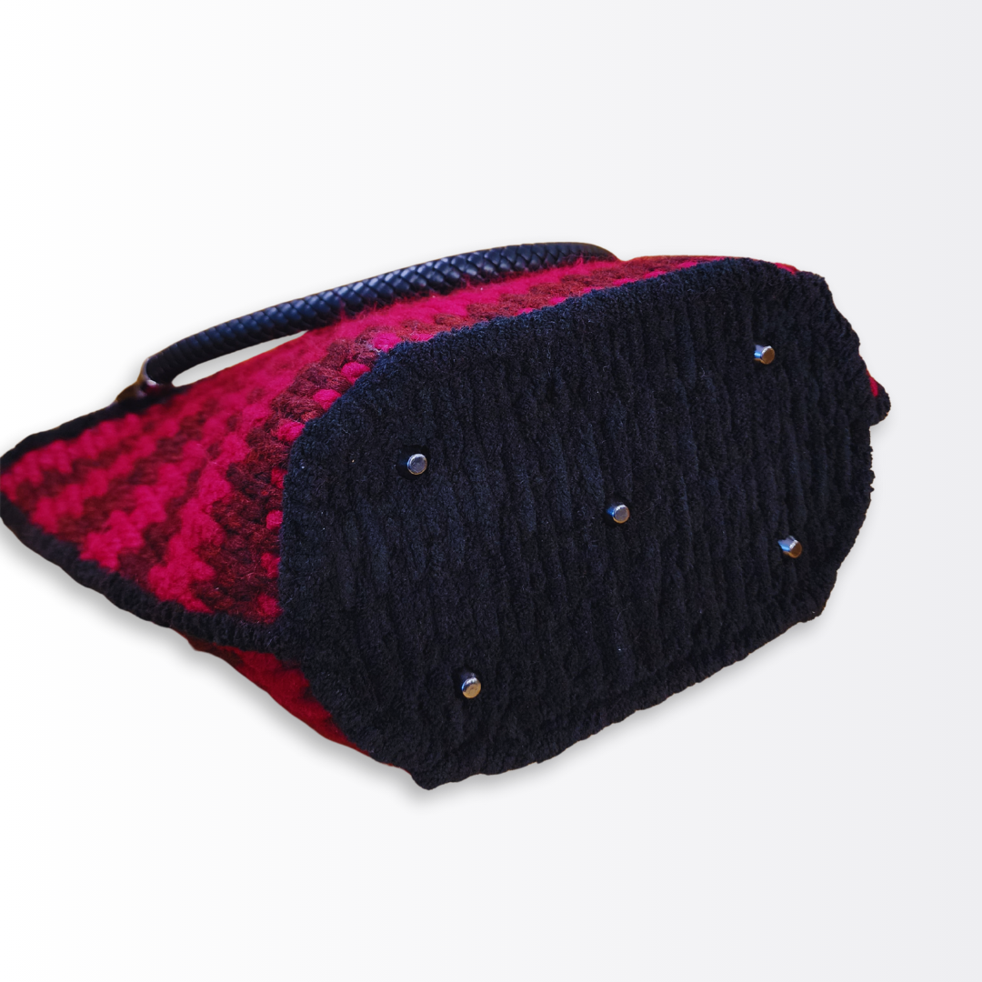 Bottom view of the structured crimson bag showing the protective gunmetal purse feet and high-density black fiber base.