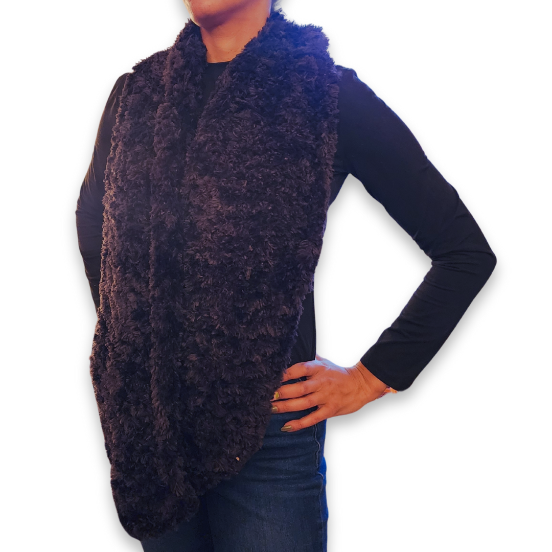 A person models the wide dark gray/black faux fur infinity scarf, worn long, emphasizing the luxurious texture.