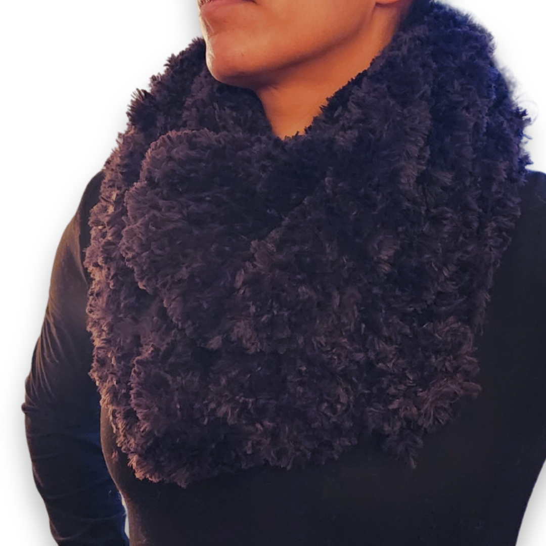 A close-up view of the wide dark gray/black faux fur infinity scarf looped twice around the neck.