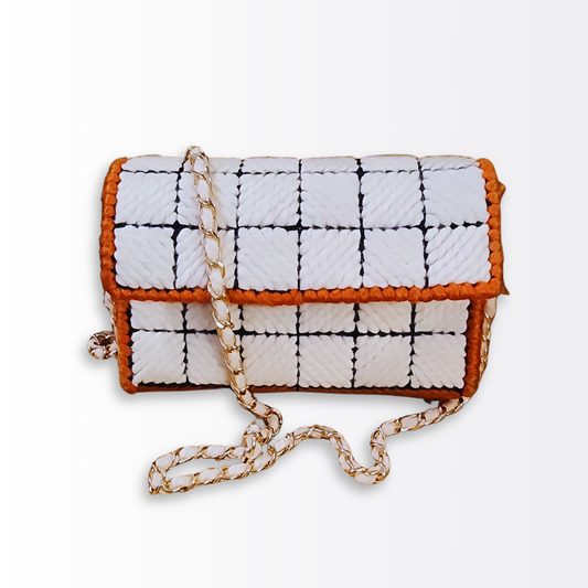 Front-facing view of the Afro Anime Crossbody showcasing the black-outlined checkered pattern, orange edging, and the 47-inch gold woven chain strap.
