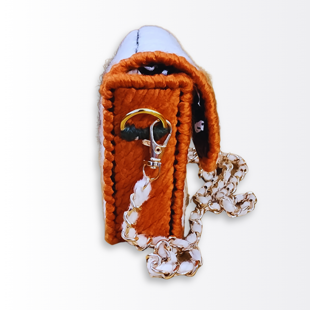 Side profile of the crossbody showing the forest green yarn accents used to anchor the gold D-rings.