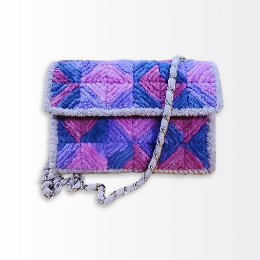 Front angled view of the $89 mini bag emphasizing the tactile texture of the chenille diamond embroidery.