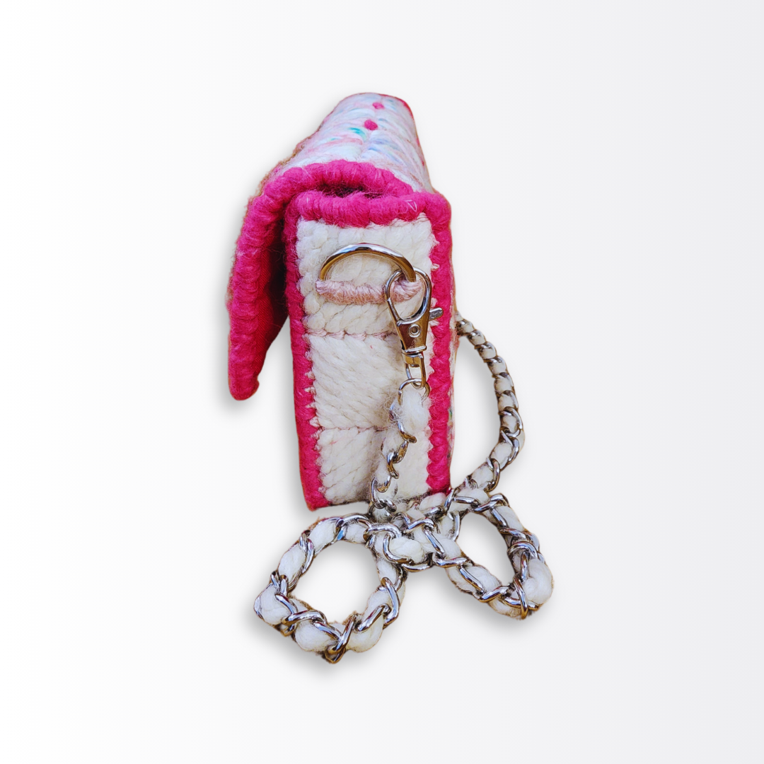 Side profile of the structured mini clutch demonstrating the 2-inch depth and the rigid architectural silhouette maintained by the permanent internal frame.