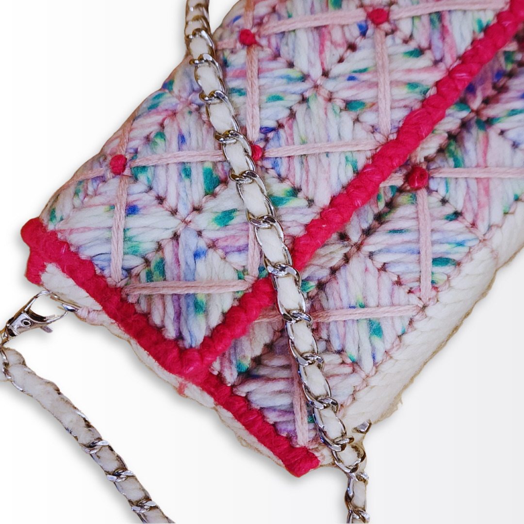 Close-up detail of the multi-layered Bargello technique, featuring speckled yarn, the structural crisscross overlay, and tiny hand-embroidered French knots at the intersections.