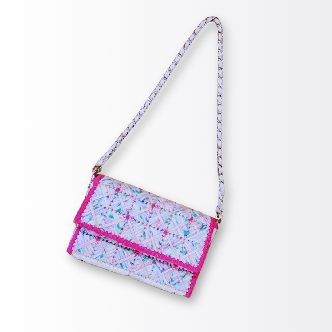 Full-length view of the Strawberry Shortcake bag with the 26-inch silver chain strap extended, emphasizing its modern shoulder-bag silhouette.