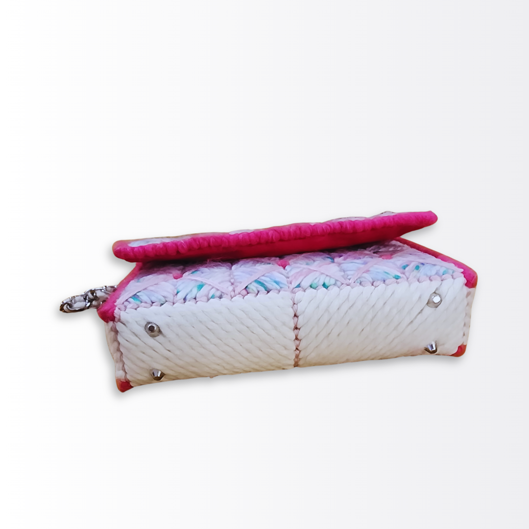 Bottom view of the mini clutch base showing the high-density white fiber finishing and four protective silver purse feet.