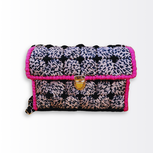 Front-facing view of the X Marks the Spot Leopard Mini Clutch highlighting the gold push-lock clasp and the bold pink and leopard fiber contrast.