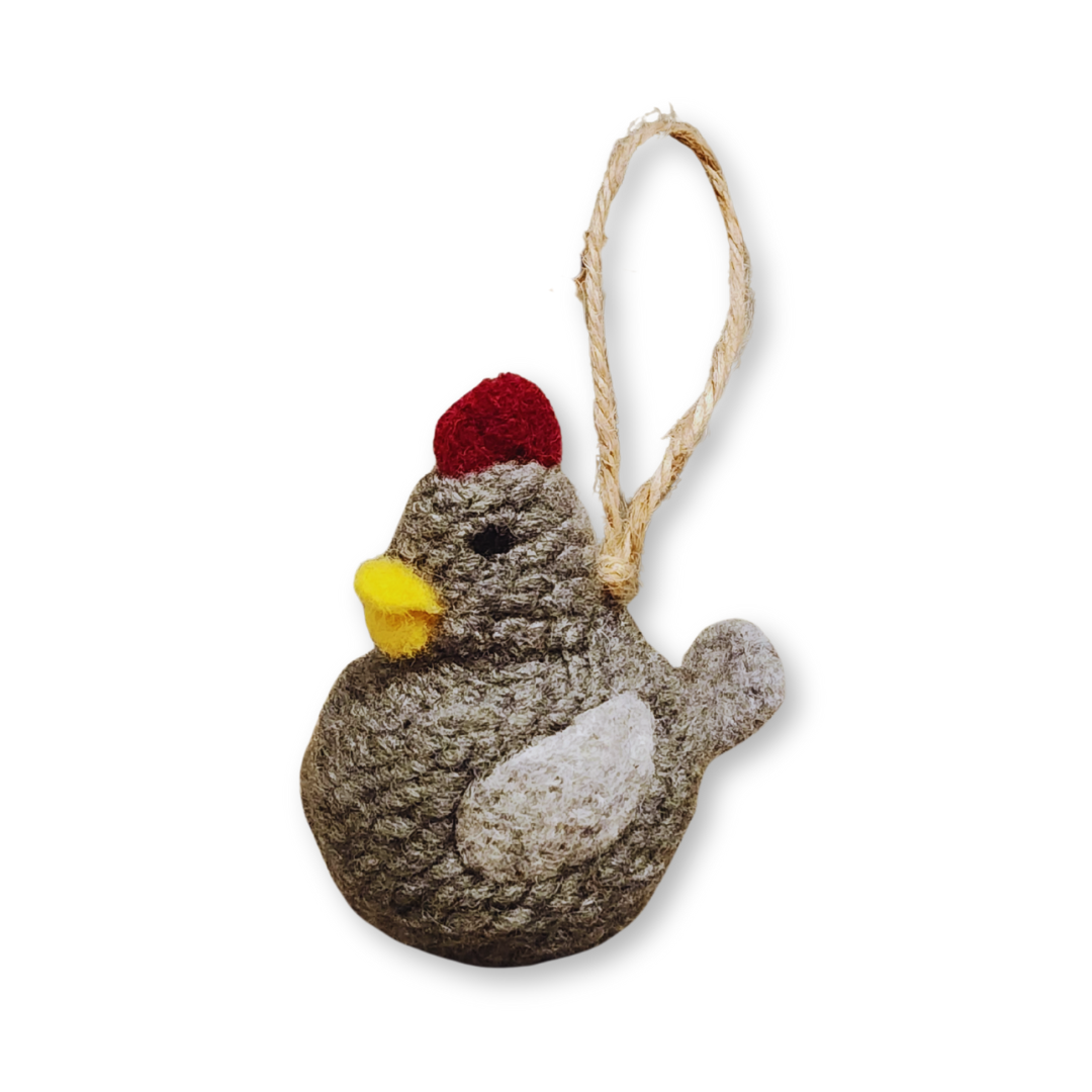 A front view of the Grey chicken bobble, showing its yellow beak, red comb, and light grey wing patch, isolated on a white background.