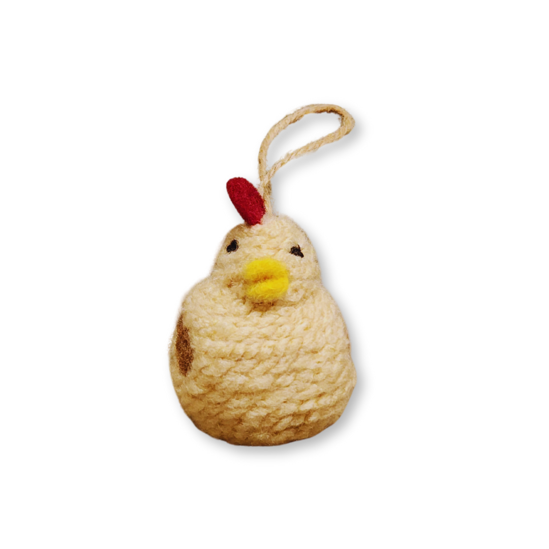 A front view of the Tan chicken bobble ornament, showing the light beige body, yellow beak, and tiny black eye, isolated on a white background.