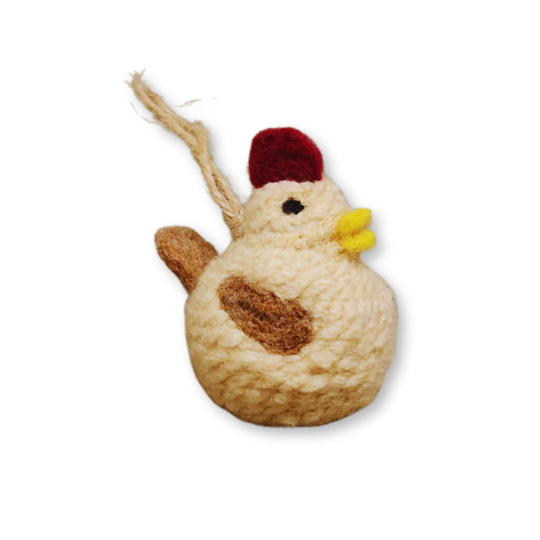A side view of the Tan chicken bobble ornament, highlighting the brown patch on its body and the red comb, isolated on a white background.