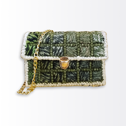 Front-facing view of the Verdant Lattice Bargello Mini Clutch ($105) showcasing the green ombre diagonal geometric pattern and polished gold push-lock clasp.