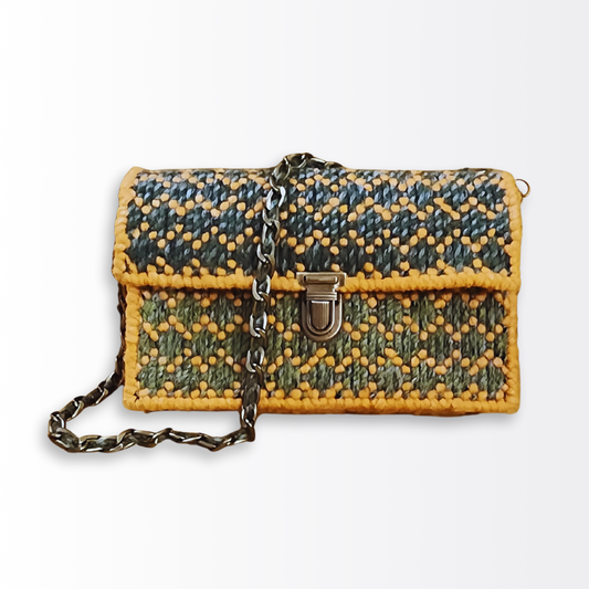 Front view of the Golden Verdant Bargello Mini Clutch featuring a hand-embroidered diamond stitch pattern in mustard yellow and green ombre yarn with an ornate bronze push-lock clasp.