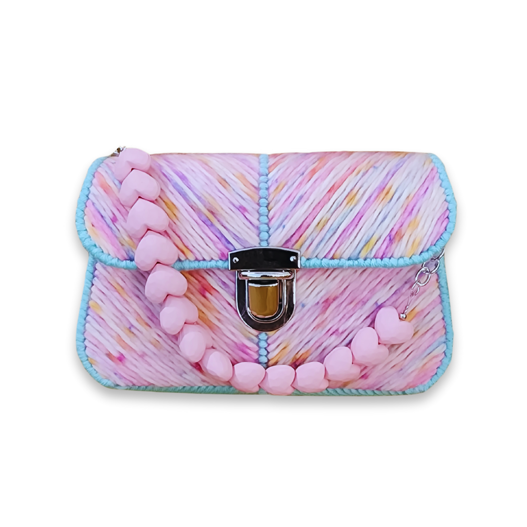 Front view of the Cotton Candy Mini Clutch showing the vibrant pink, yellow, and blue chevron embroidery and the pink acrylic heart-string handle.