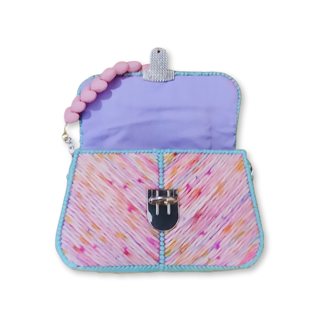 The clutch opened to showcase the hand-sewn pastel purple cotton lining and the clean, professional finish of the internal frame.