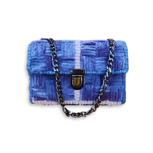 Front view of the Galaxy Checker Mini Clutch showcasing a basketweave stitch pattern in shades of celestial blue and purple fluffy yarn. The design features a gunmetal metal chain strap and a matching gunmetal push-lock clasp.