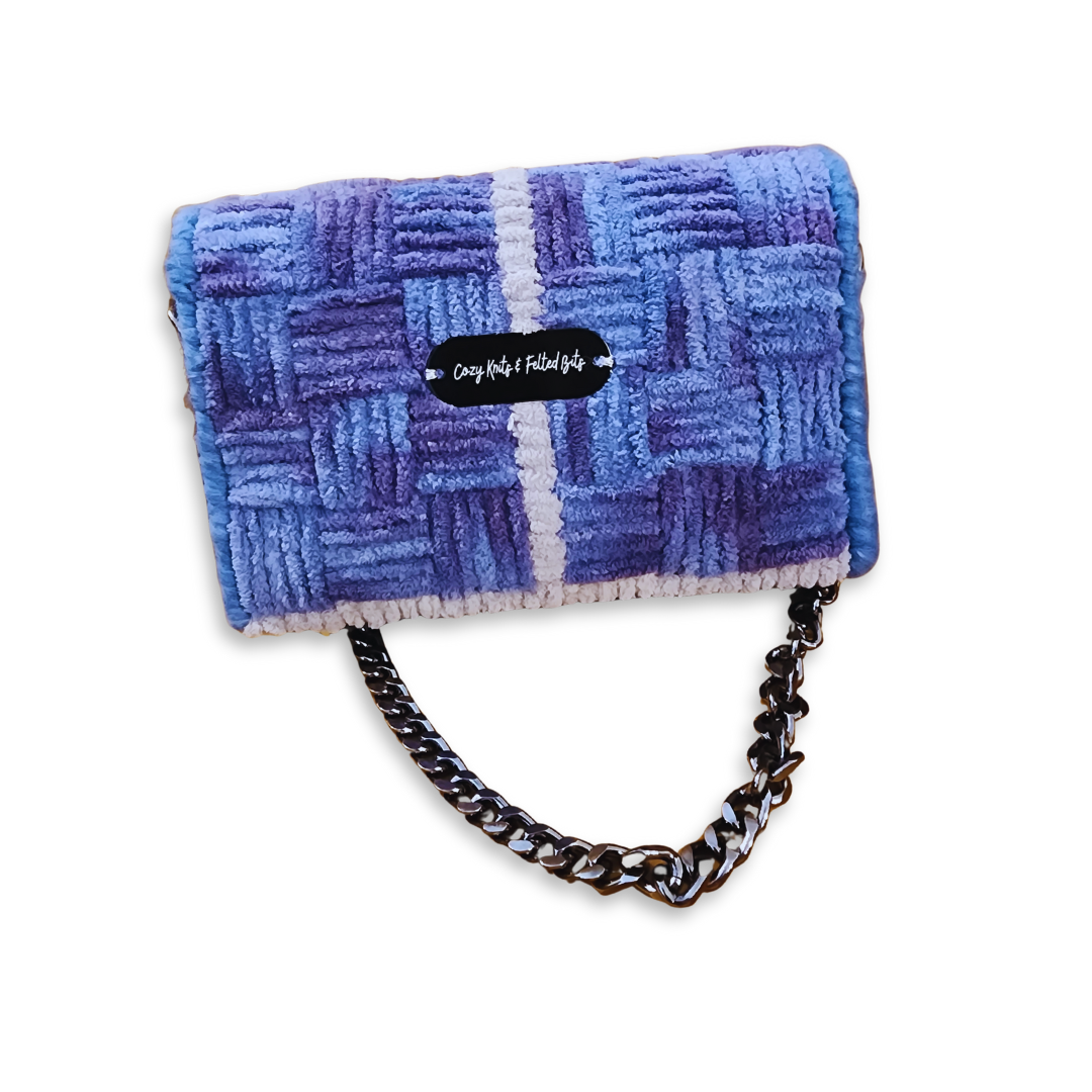 Back view of the Galaxy Checker Mini Clutch featuring the CKFB Original logo plate. The blue and purple ombre effect of the fluffy yarn is clearly visible across the one-of-a-kind design.