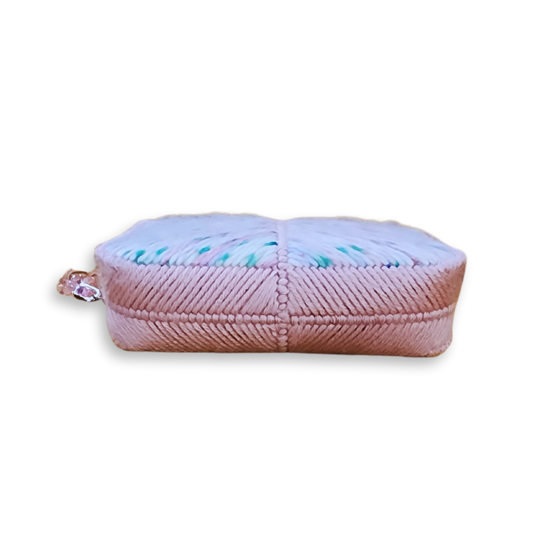 Bottom view of a structured fiber bag base, showing the high-density stitching and rigid internal frame that allows the clutch to stand tall.