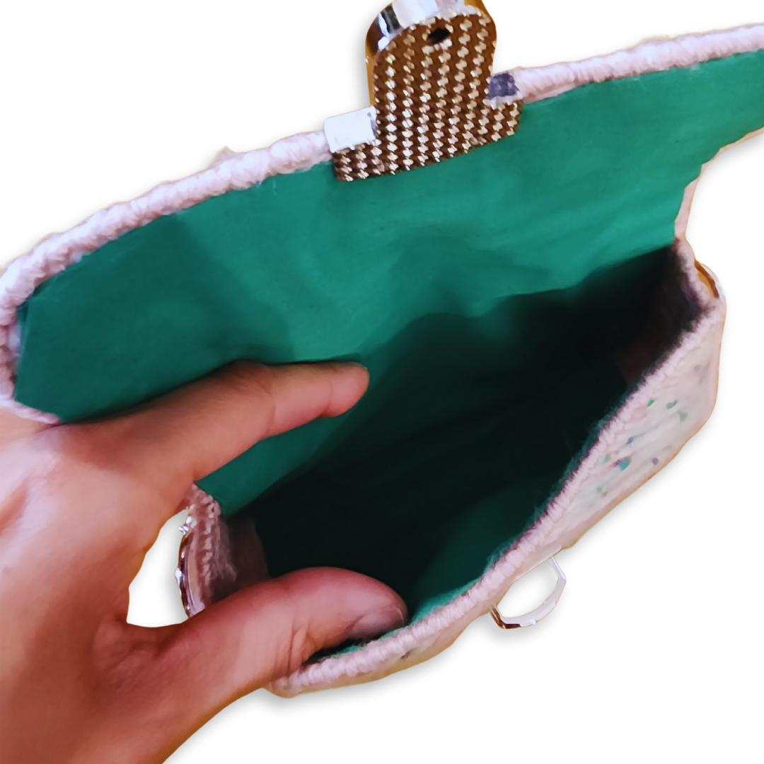 Close-up of the bright green lining and hand-sewn interior of a whimsical statement bag, emphasizing the bespoke fiber art quality.