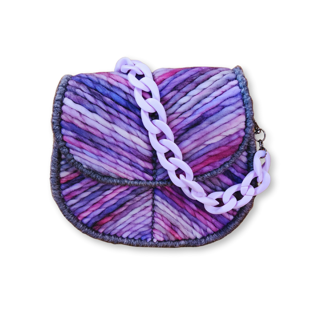 Front view of the OOAK Lavender Dream Mini Saddlebag featuring a hand-dyed lavender ombre Merino wool exterior and a precise chevron stitch pattern. The bag is accented with a matte pastel purple acrylic chain strap.
