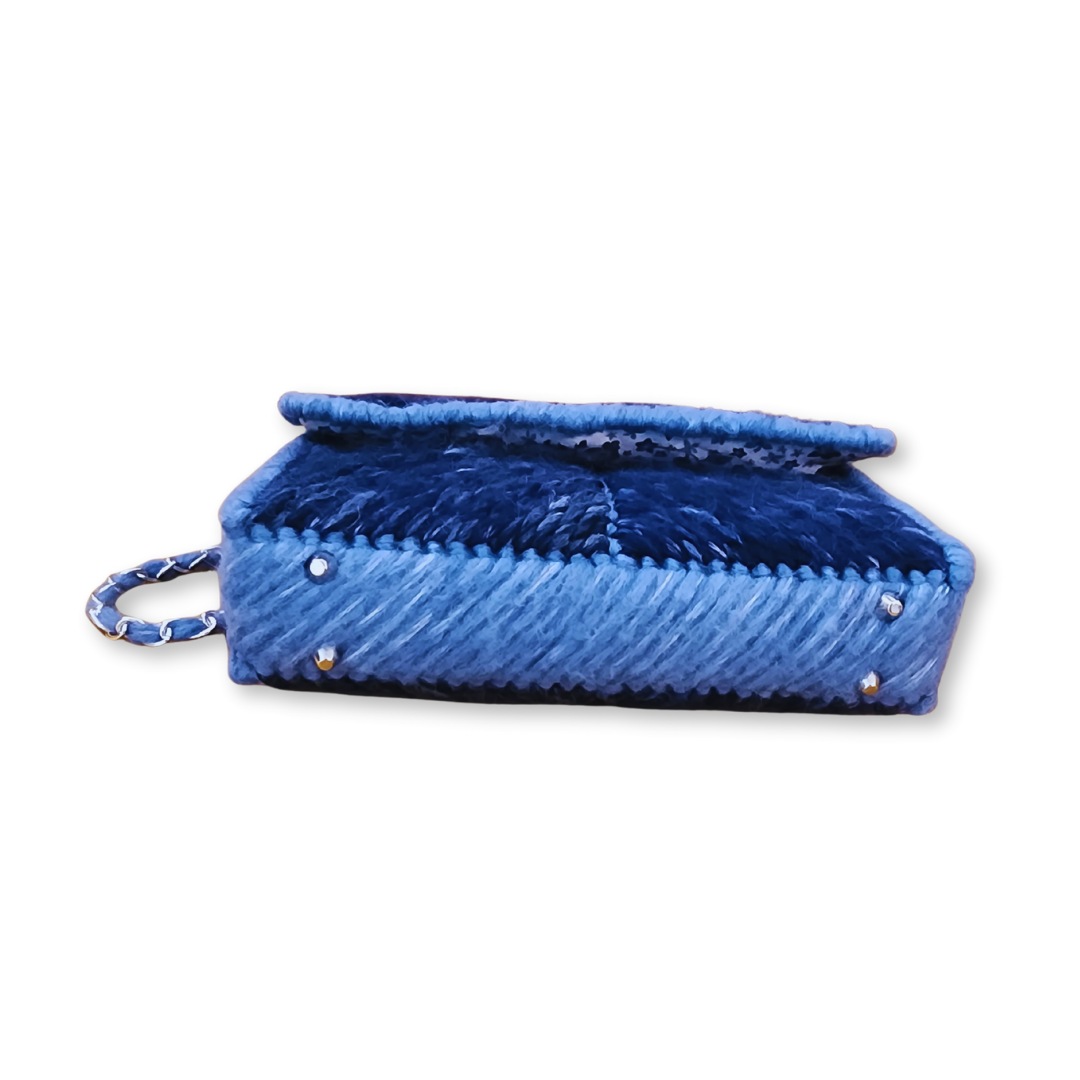 Bottom view of the structured fiber bag base featuring protective silver purse feet and high-density navy embroidery.