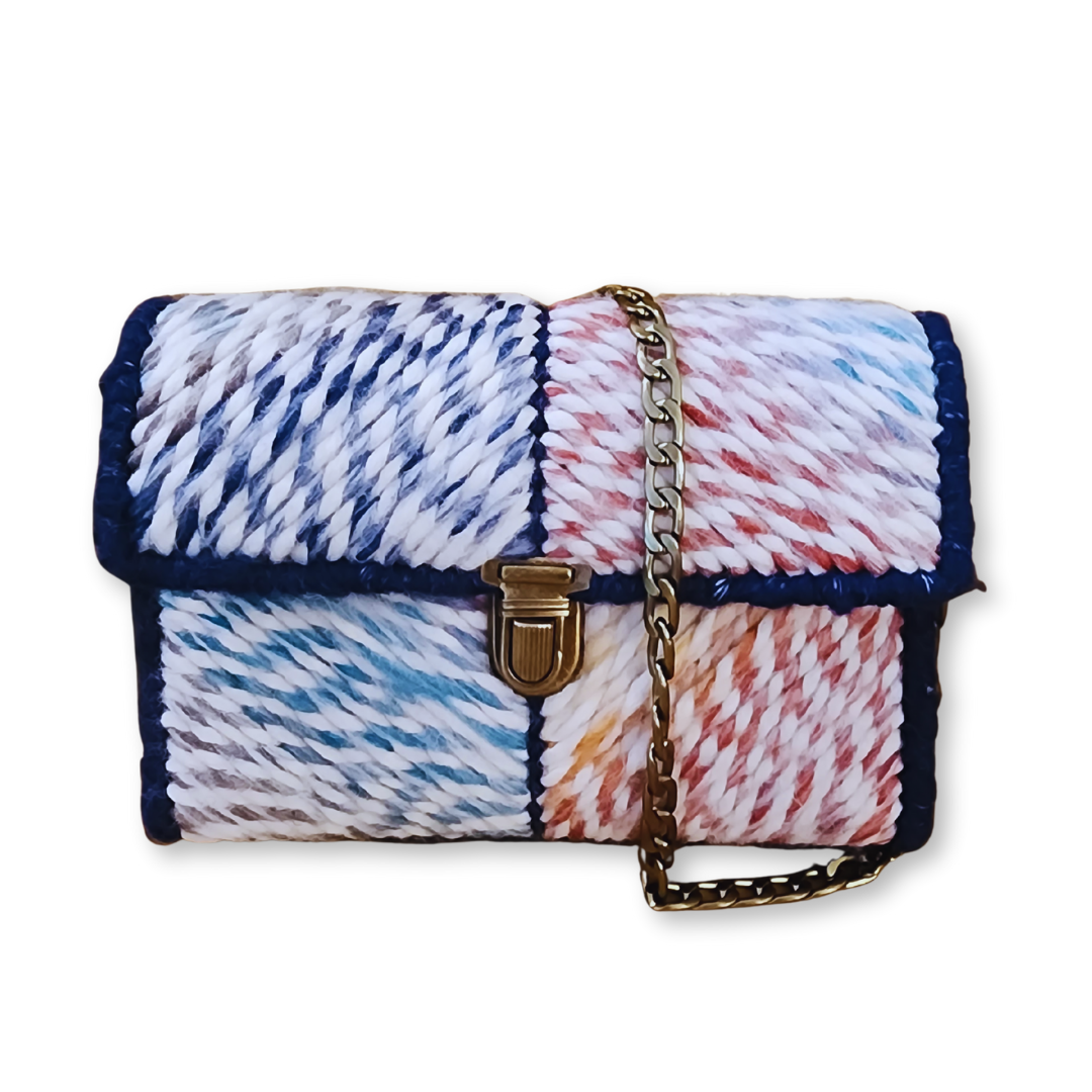 Front view of the Navy Rainbow Patchwork Mini Clutch featuring a mauve rainbow ombre yarn and navy blue side panels. The image showcases the ornate bronze push-lock clasp and the 9mm bronze chain strap.