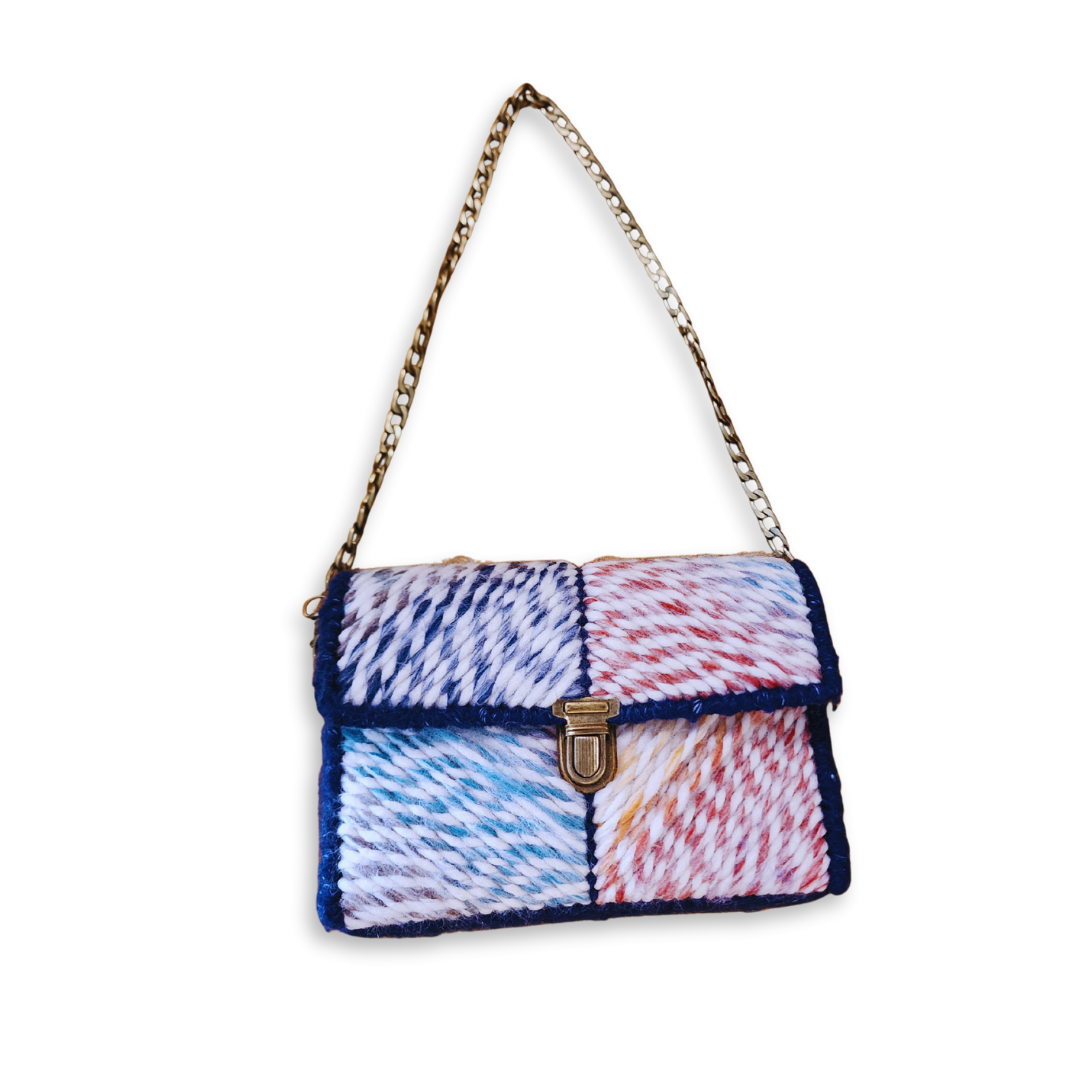 Full front view of the whimsical statement bag with the 23" bronze chain strap extended. The rigid internal frame ensures the bag maintains its sharp silhouette.