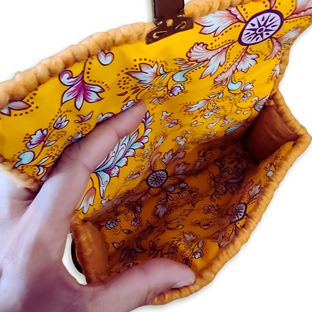 Close-up interior shot focusing on the bespoke finishing of the golden honey floral lining and the secure internal frame construction.