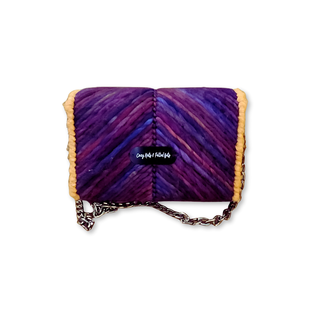 Back view of the Purple Chevron Clutch featuring the CKFB Original logo plate. The deep purple merino wool pattern continues seamlessly across the back of the one-of-a-kind design.