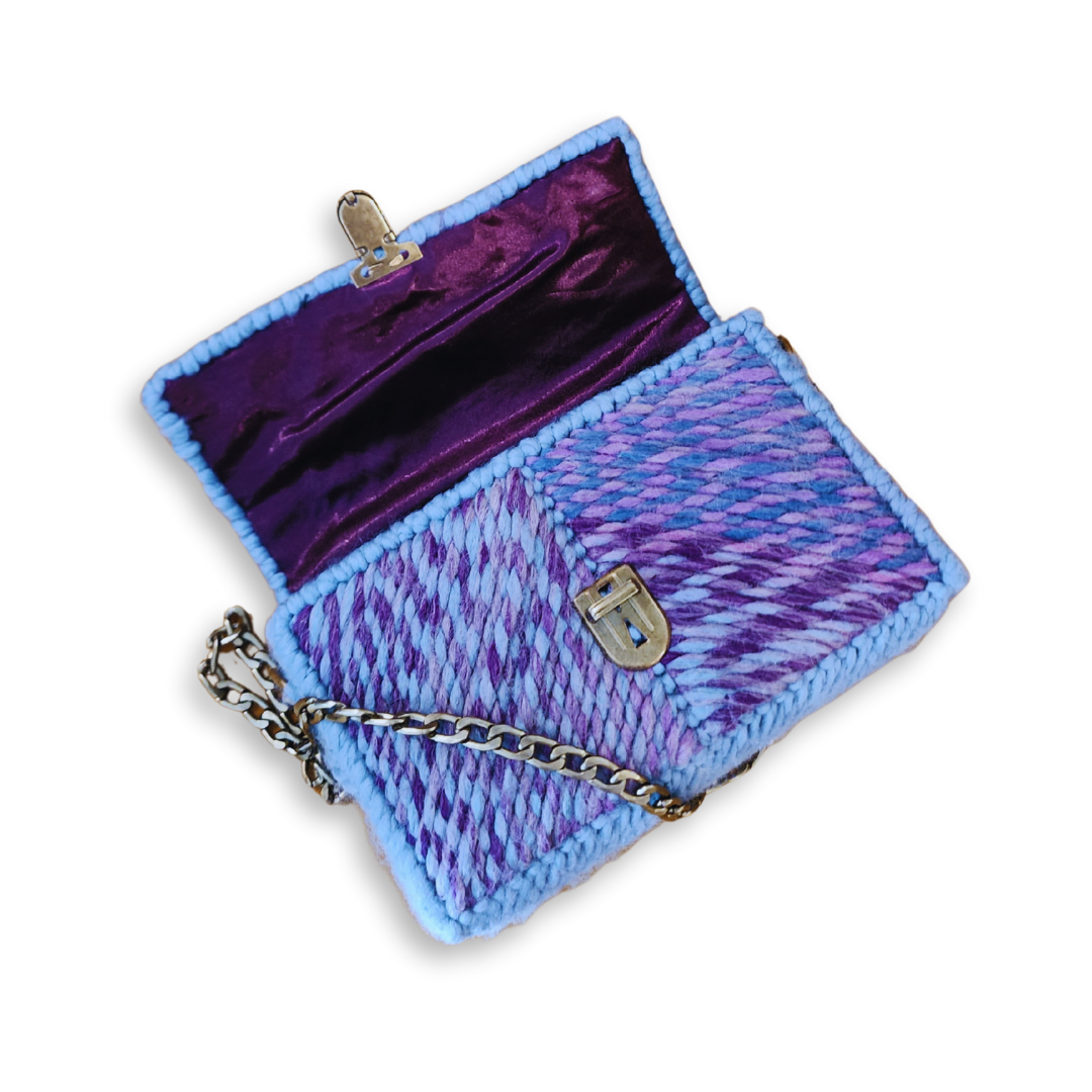 High-angle view of the Purple Ombre Patchwork Mini Clutch opened to reveal the hand-sewn dark purple satin lining. The image highlights the bespoke finishing and the secure attachment of the bronze chain strap.