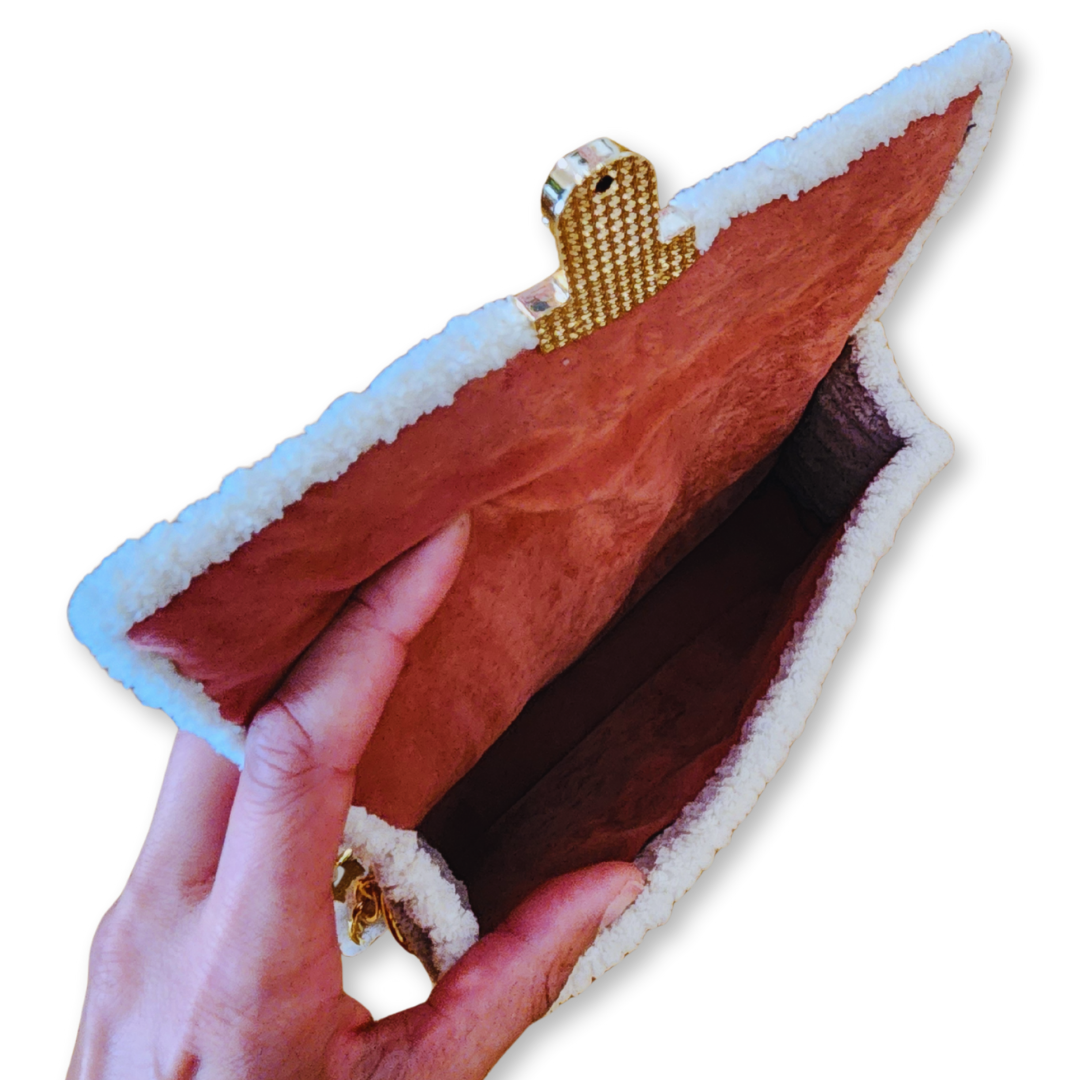 Close-up of the crimson red faux suede interior and the underside of the gold push-lock clasp, demonstrating the high-end, tactile quality of the chenille fiber art.