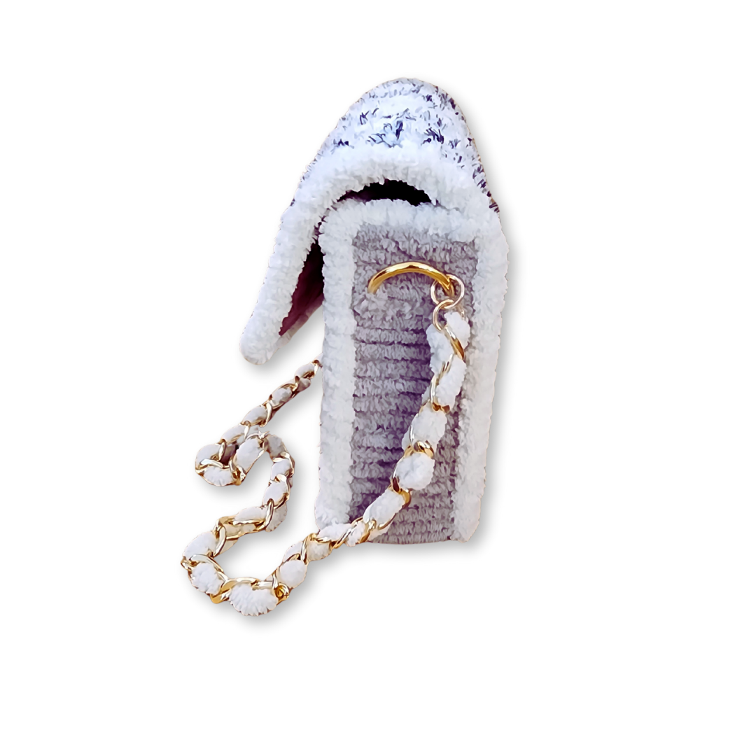 Side profile view of the structured mini clutch showcasing its 2-inch depth and the light grey chenille yarn side panels. The gold lobster claw attachment and woven chain detail are clearly visible.