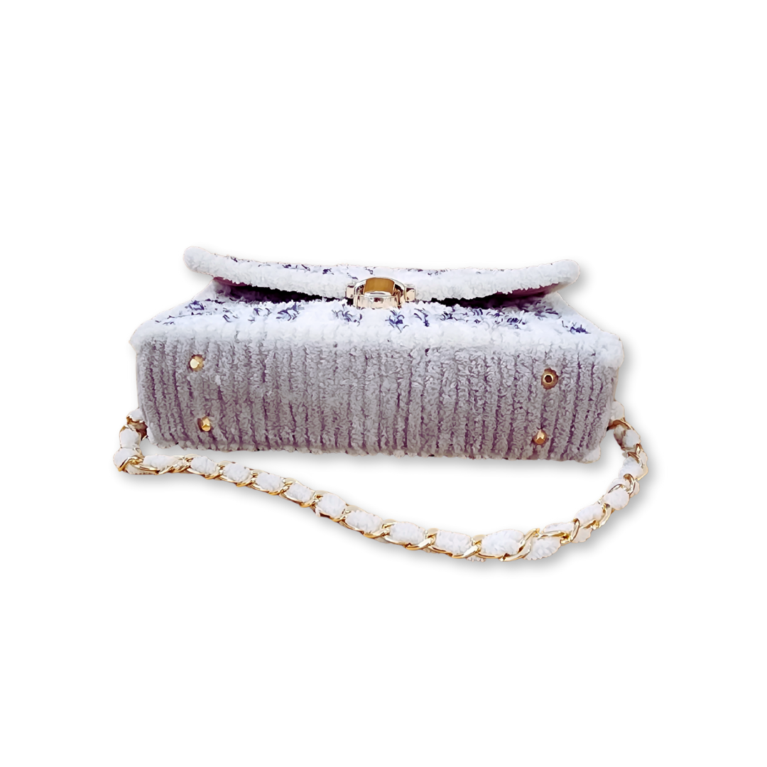 Bottom view of the Seaside Checkerboard Clutch highlighting the protective gold purse feet and the continuation of the light grey chenille accents along the rigid base.