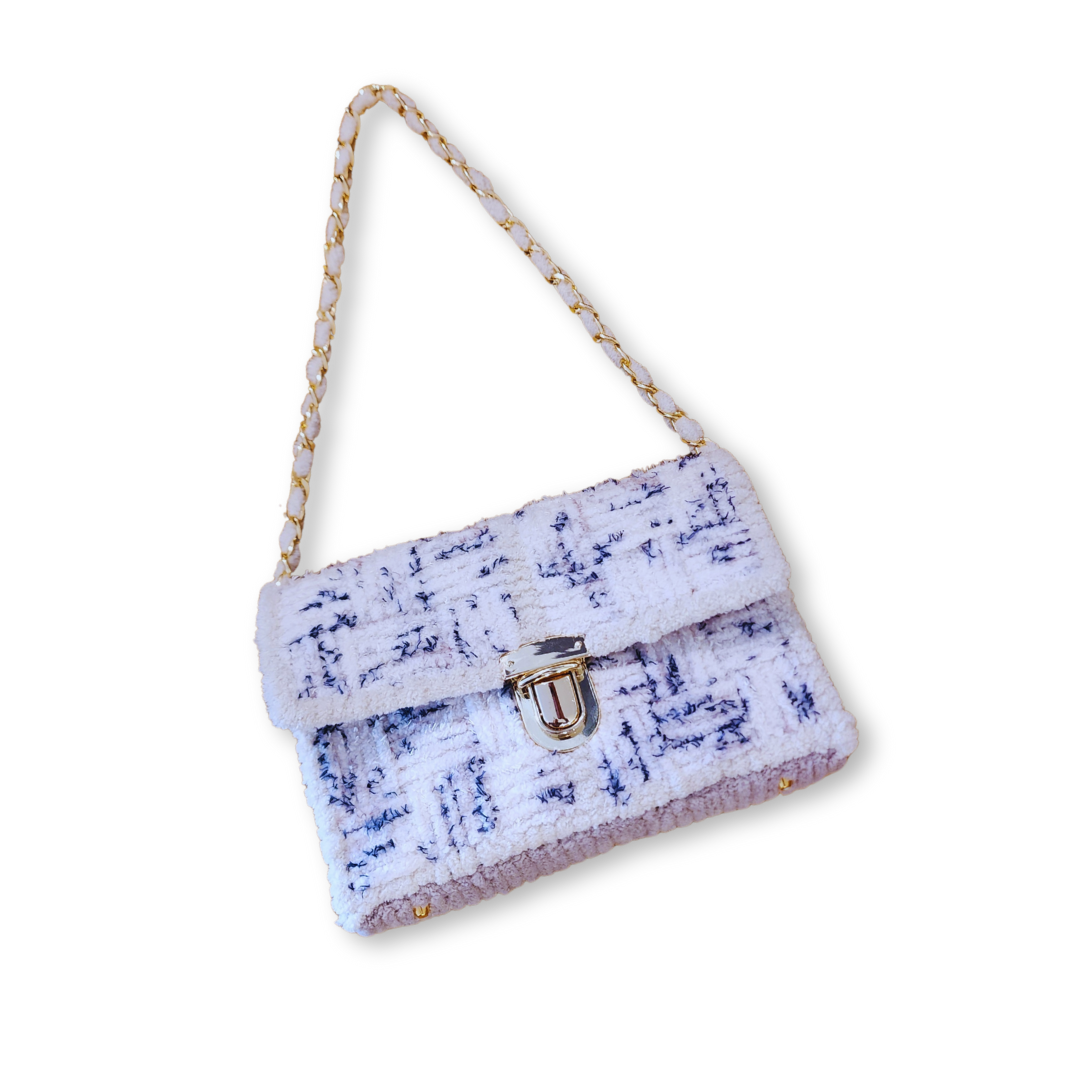 Full angled view of the Seaside Checkerboard Mini Clutch with the 21" gold woven chain strap extended, showcasing the bag's sharp, professional silhouette.