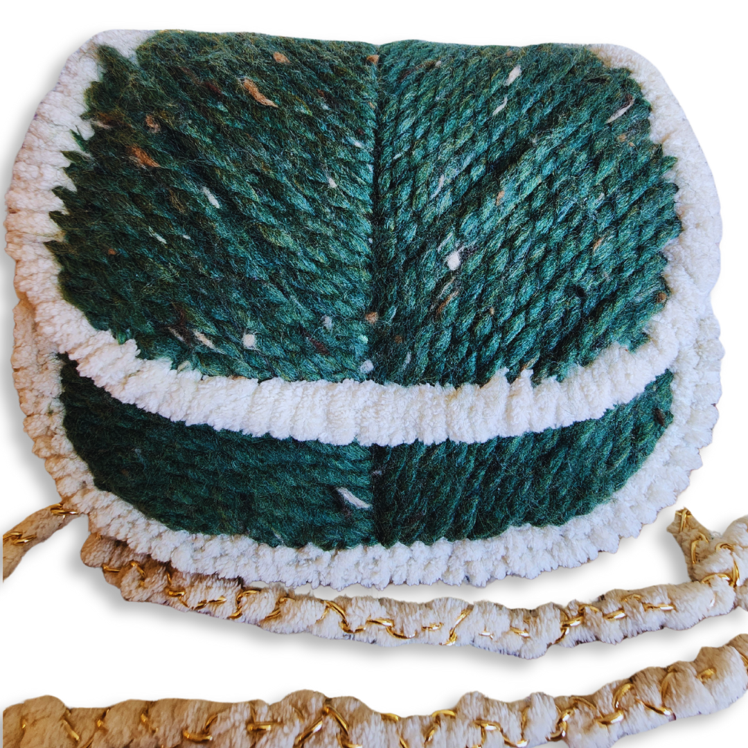 A close-up shot of the bag's front, highlighting the detailed chevron embroidery pattern on the deep forest green yarn and the plush white chenille trim.