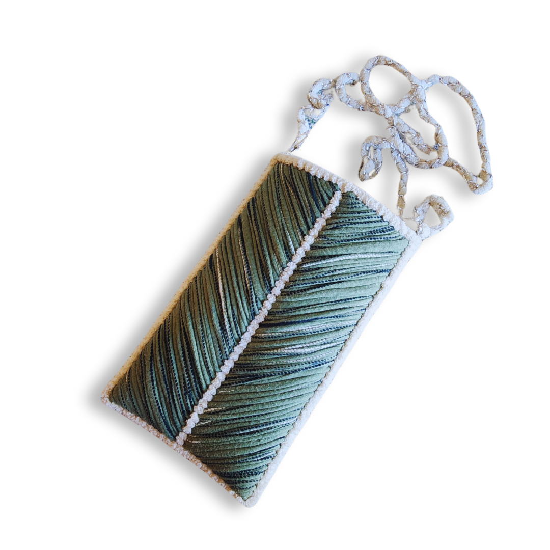 A handmade embroidered phone purse with a green chevron pattern, white chenille trim, and a white woven chain strap, isolated on a white background.