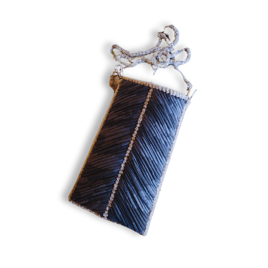 A handmade embroidered phone purse in deep gray and light beige, showing the structured chevron pattern and the woven chain strap, isolated on a white background.