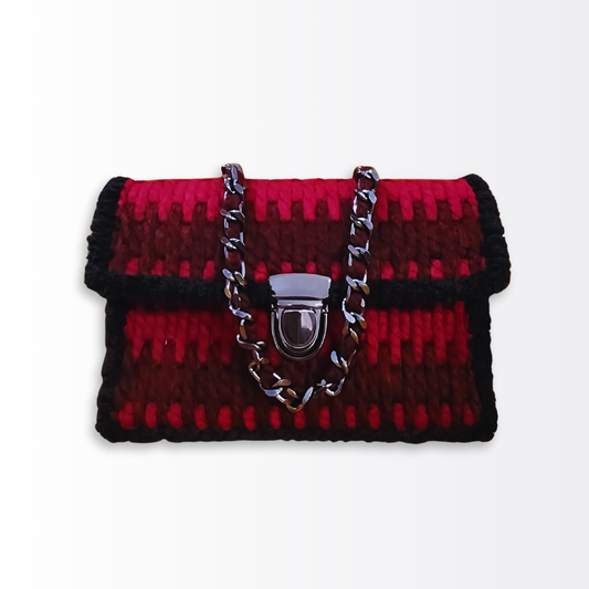 Front view of the Crimson Rhythm Mini Shoulder Bag ($89) showcasing the two-tone red Bargello-style embroidery and polished gunmetal push-lock clasp.