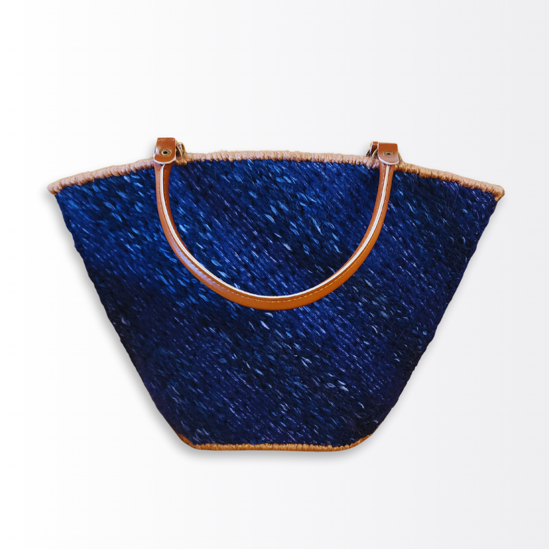 Angled front view of the Deep Sea Tote emphasizing the rigid architectural silhouette and the multi-tonal depth of the navy blue yarn blend.