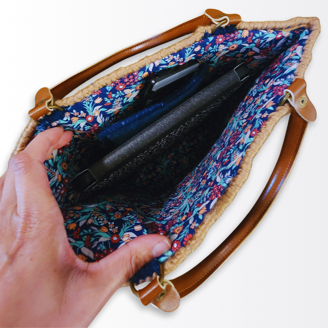 Overhead interior view of the Navy Scalloped Tote demonstrating what fits inside, including a tablet, phone, and wallet tucked into the floral-lined compartment.