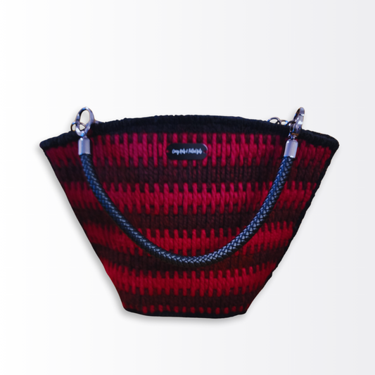  Front-facing view of the Crimson Eclipse Scalloped Artisan Tote ($249) highlighting the two-tone red Bargello stitch pattern and braided leather handles.