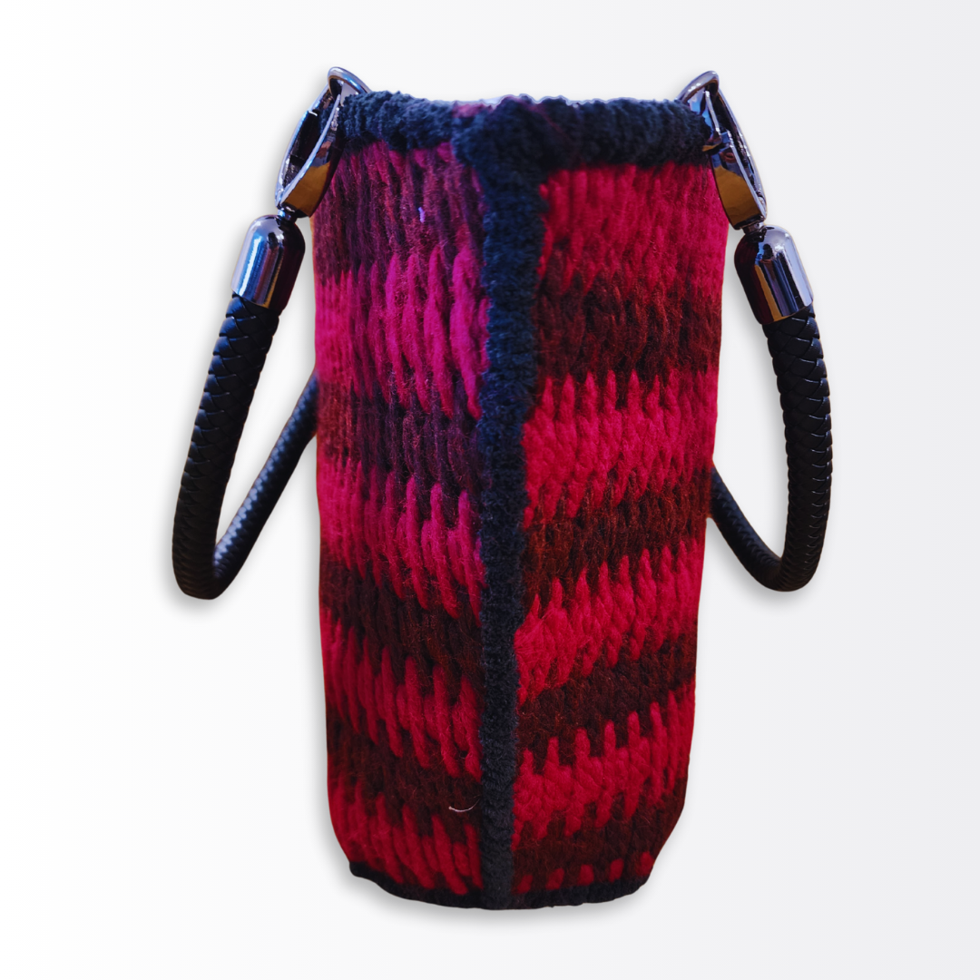 Side profile of the structured red tote demonstrating the rigid architectural silhouette and plush black edging.