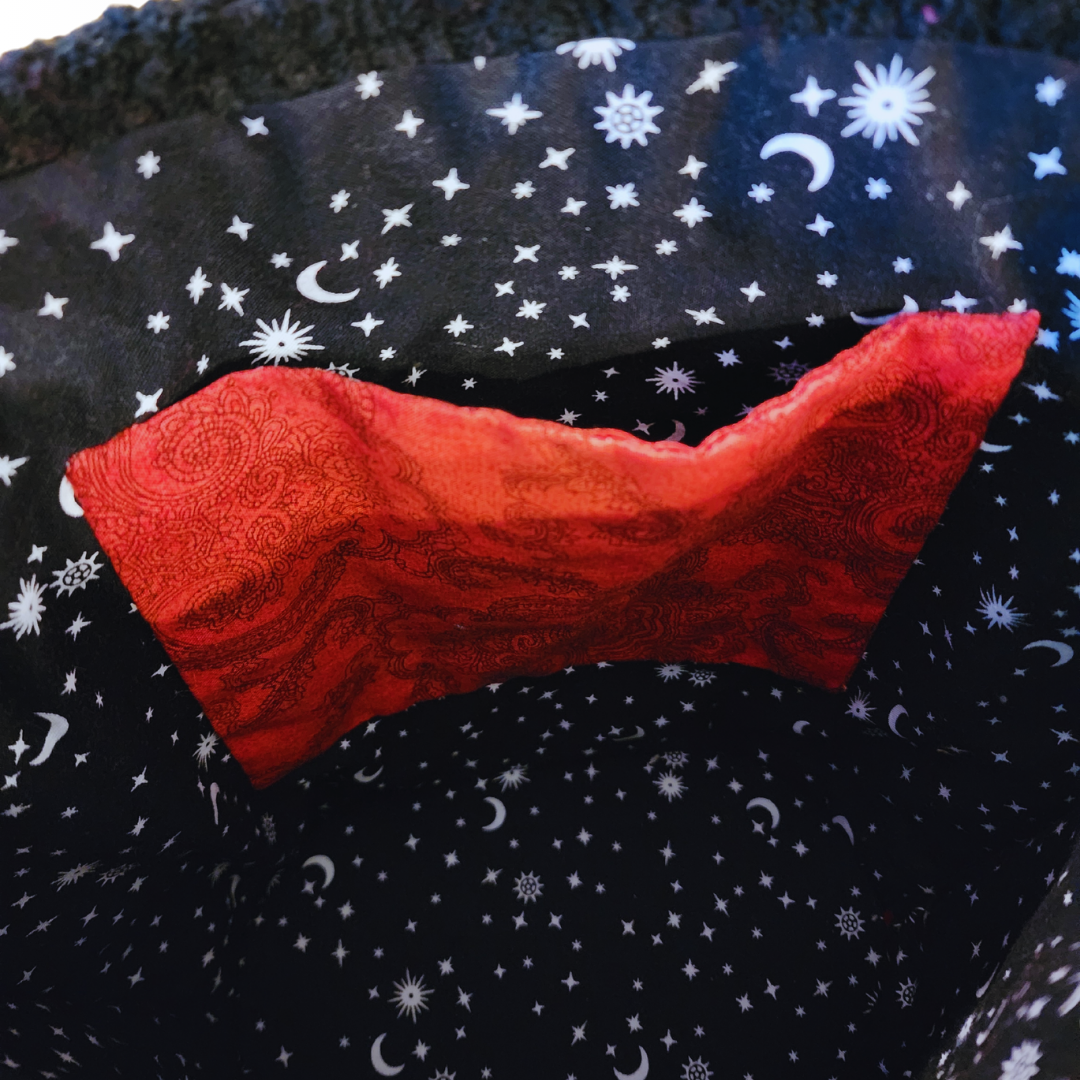 Macro shot of the celestial print cotton lining and the high-end finishing of the internal red pocket.