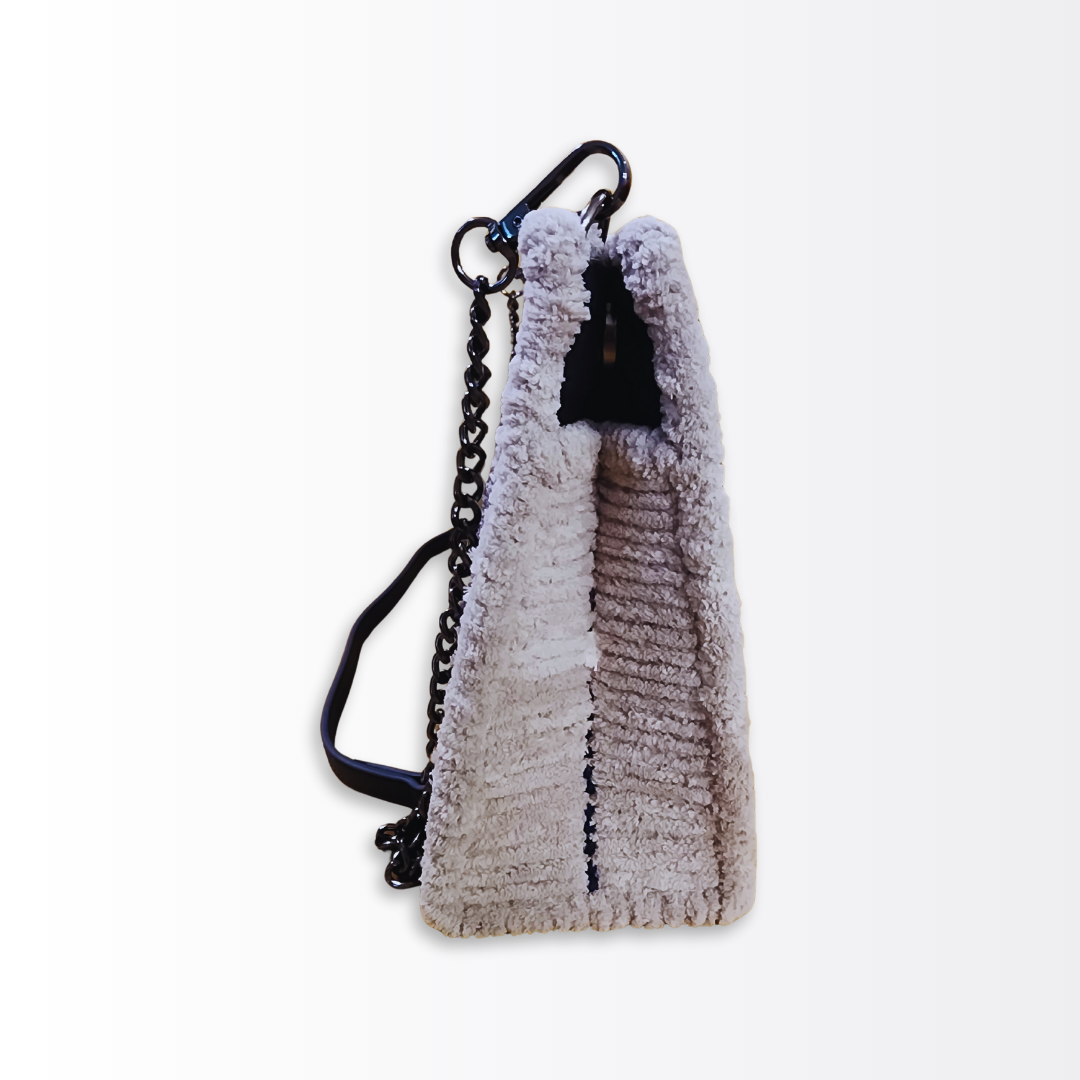 Side profile of the large artisan bag demonstrating the 4-inch depth and rigid architectural frame finished in plush grey chenille.