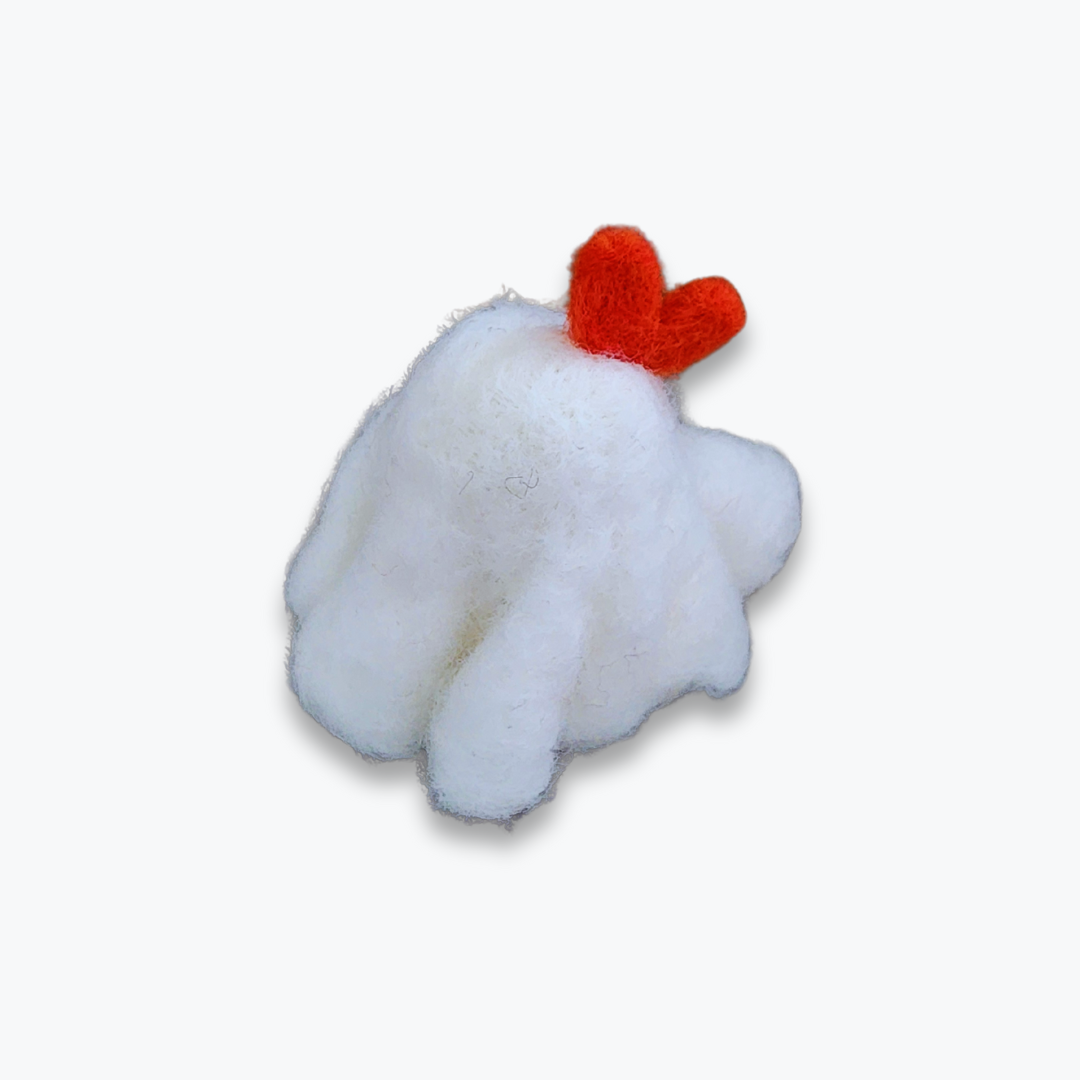 A large handmade felted ghost figurine with an orange bow, a cute smiling mouth, and pink cheeks, viewed from a high angle against a plain white background.