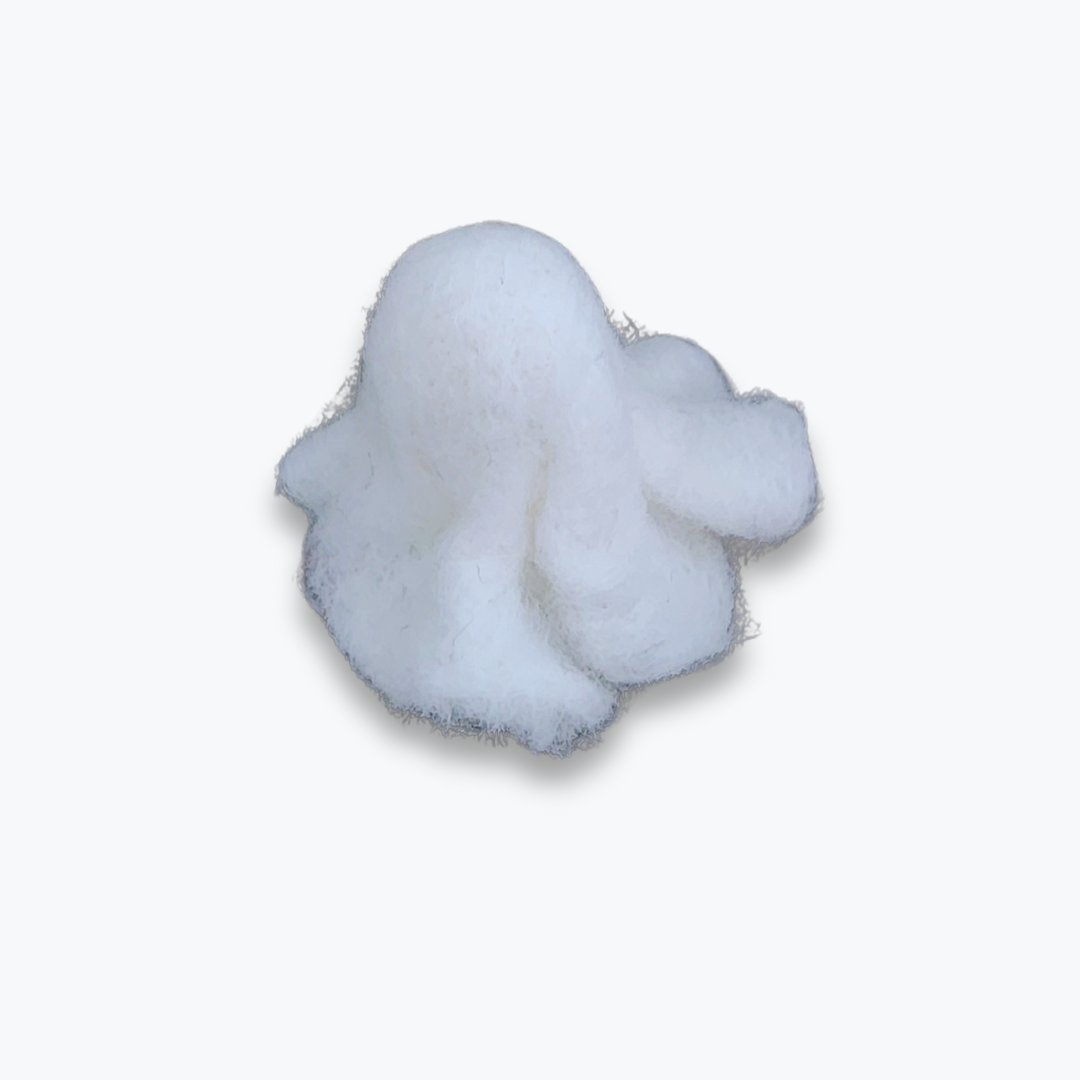 A small handmade felted ghost figurine with a wide black smiling mouth and small eyes, viewed from a high angle against a plain white background.