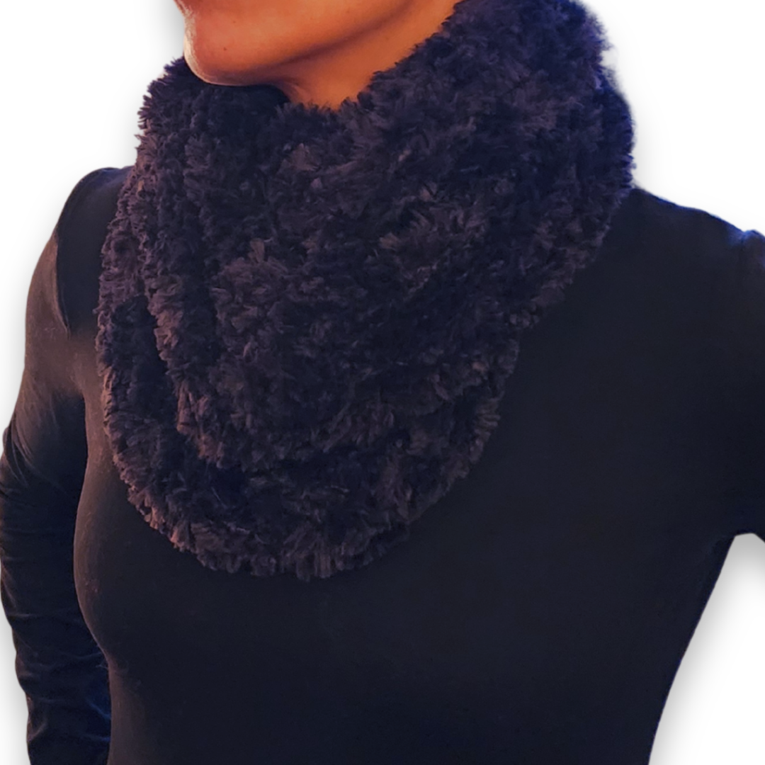 A close-up of the skinny black faux fur infinity scarf looped high, emphasizing the deep color and soft feel.