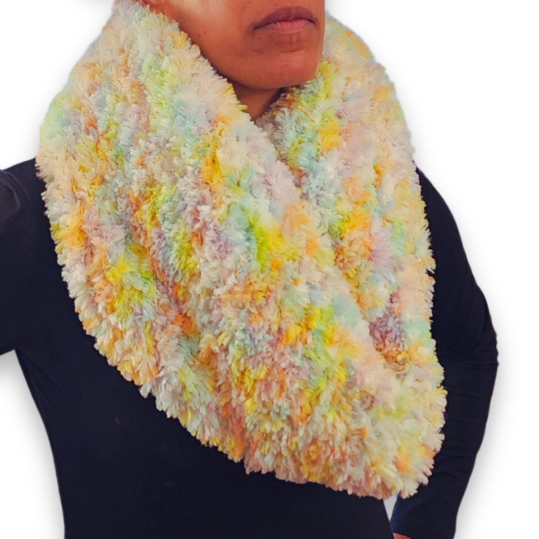 A person models the wide, multi-colored "sprinkles" faux fur infinity scarf, looped once and worn high on the neck.