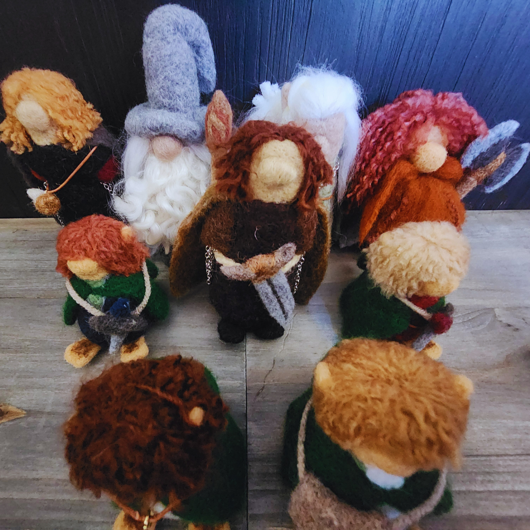 Aerial group photo showing all nine members of the Fellowship of the Ring as needle-felted characters.